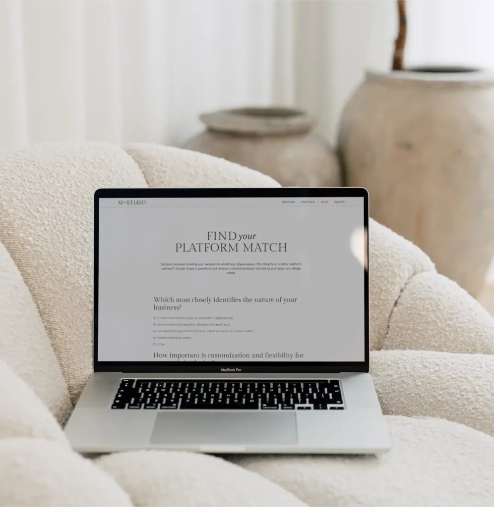 Laptop on a sofa chair with a mock up of the M Studio Platform Match quiz on the screen